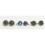 Three pairs of silver earrings: one pair set with a marcasite cluster, a pair of flower head and