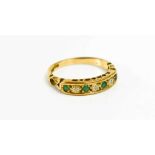 A 9ct gold emerald and diamond seven stone ring, set with four emeralds and three diamonds, size