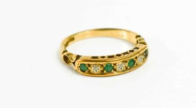A 9ct gold emerald and diamond seven stone ring, set with four emeralds and three diamonds, size