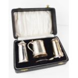 A silver cruet set, comprising salt, pepper, mustard pot and spoon, Sheffield 1957, in