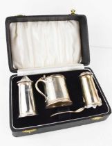 A silver cruet set, comprising salt, pepper, mustard pot and spoon, Sheffield 1957, in