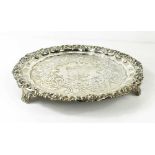 A silver salver, with embossed foliate border, engraved with crest to the centre and motto Deo