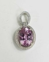 A Kunzite and diamond brilliant pendant set in 18ct white gold by Forum Design, the large oval cut
