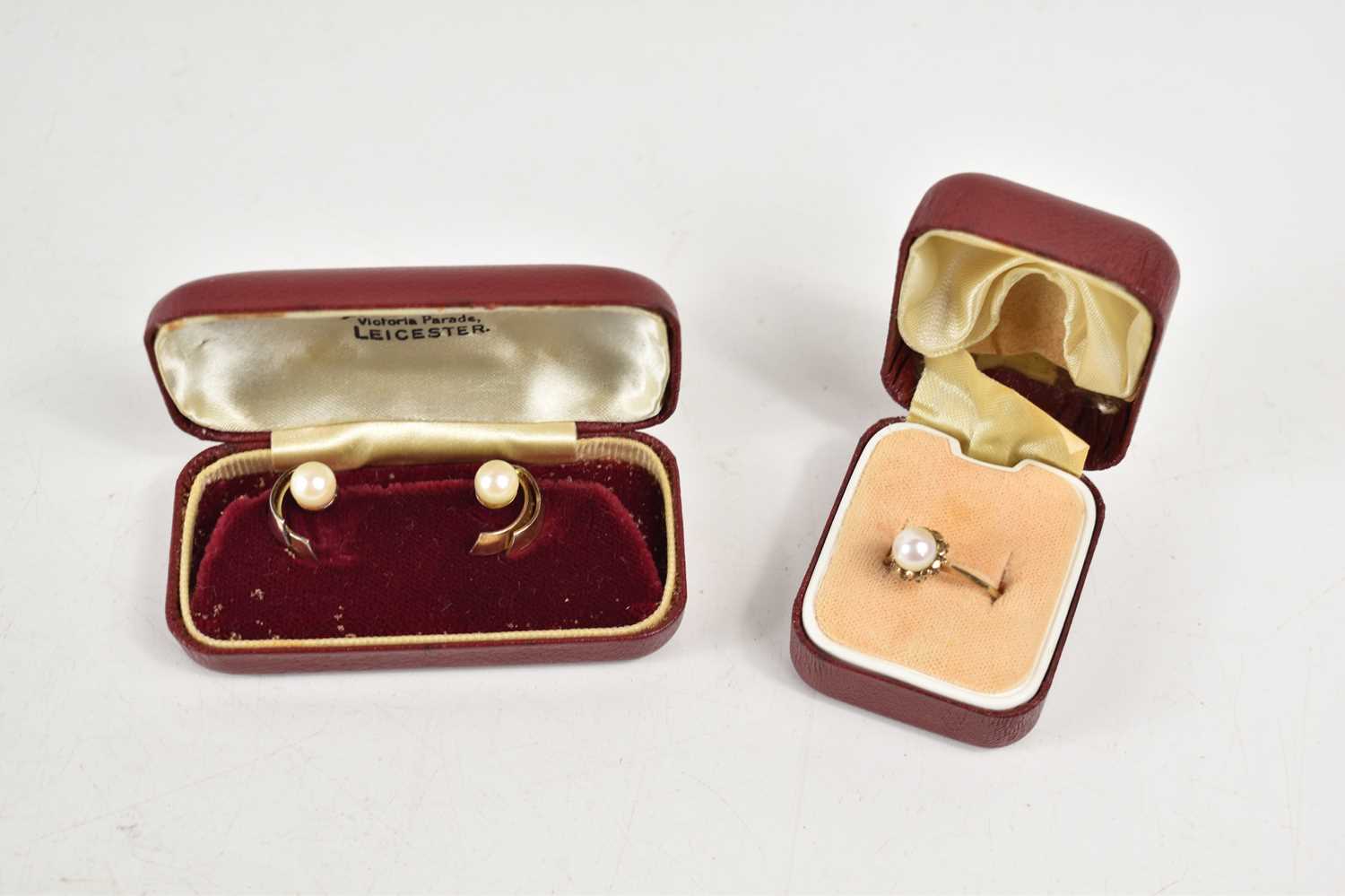 A 9ct gold and pearl dress ring, size M, 1.9g, together with a pair of pearl earrings in unmarked