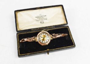 A vintage lady's gold cased wrist watch, the chapter ring dial with Arabic numerals and minute