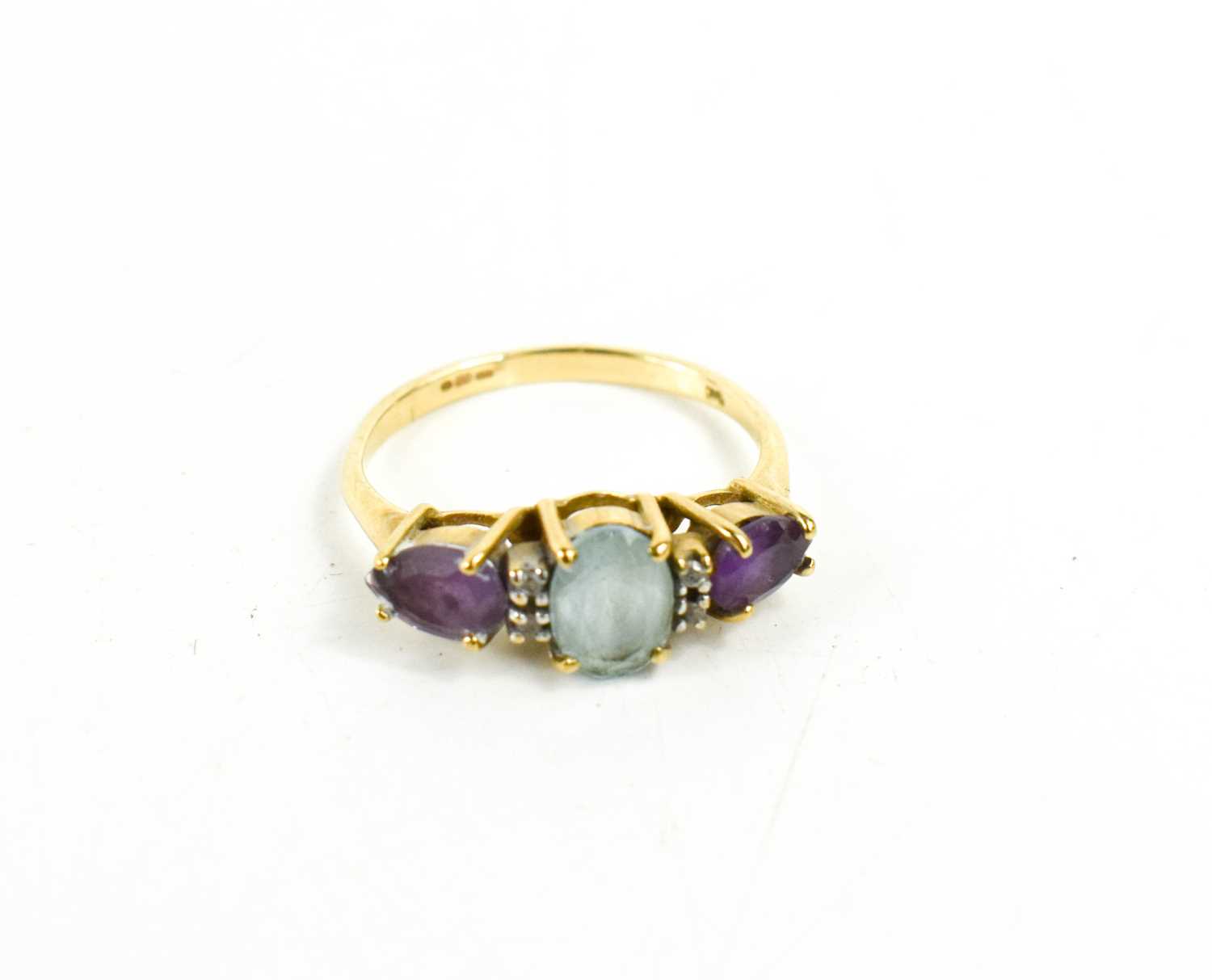 A 9ct gold, amethyst, aquamarine and diamond brilliant ring, the oval aquamarine, of approximately