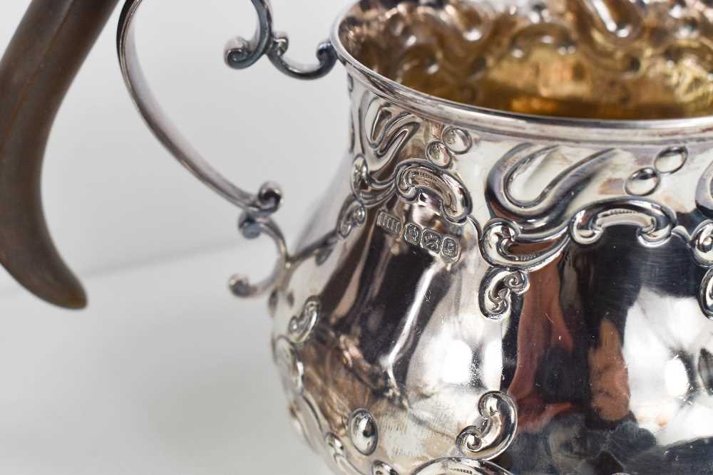 A silver tea set, embossed with Rococo style scrollwork, comprising tea pot, water pot, sugar - Image 2 of 4