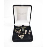 A suite of jewellery set in 9ct gold with diamond brilliants and iridescent green and pink stone,