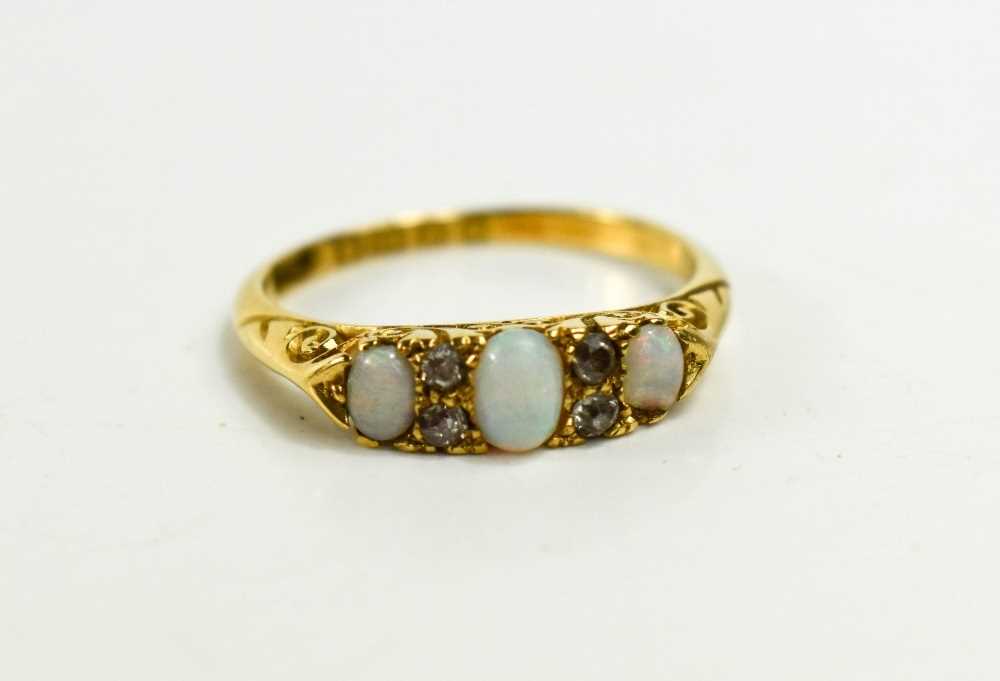 A late Victorian,18ct gold, opal and diamond ring, the three graduated oval opals interspersed