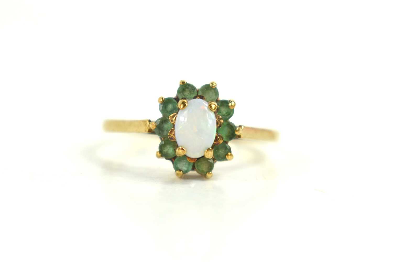 A 9ct gold, opal and emerald ring, of flowerhead form, the oval opal doublet surrounded by ten small - Image 2 of 2