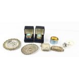 A group of silver to include two embossed trinket dishes, a coin case decorated with chased