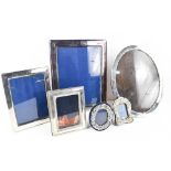 A selection of silver photograph frames: a Victorian miniature table frame and a later example of