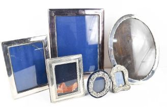 A selection of silver photograph frames: a Victorian miniature table frame and a later example of