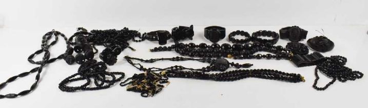 A large group of Victorian and later jet necklaces and bracelets, including a faceted jet three