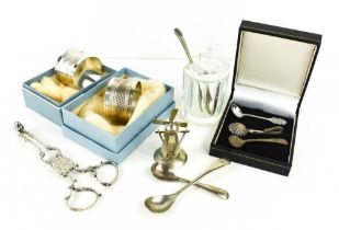 A group of silver to include two engraved napkin rings, a pair of Georgian scissor form sugar tongs,