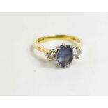 An 18ct gold, diamond and pale sapphire three stone ring, sapphire of approximately 8.4 by 6.0mm,