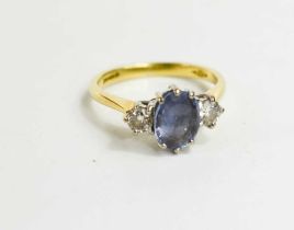 An 18ct gold, diamond and pale sapphire three stone ring, sapphire of approximately 8.4 by 6.0mm,