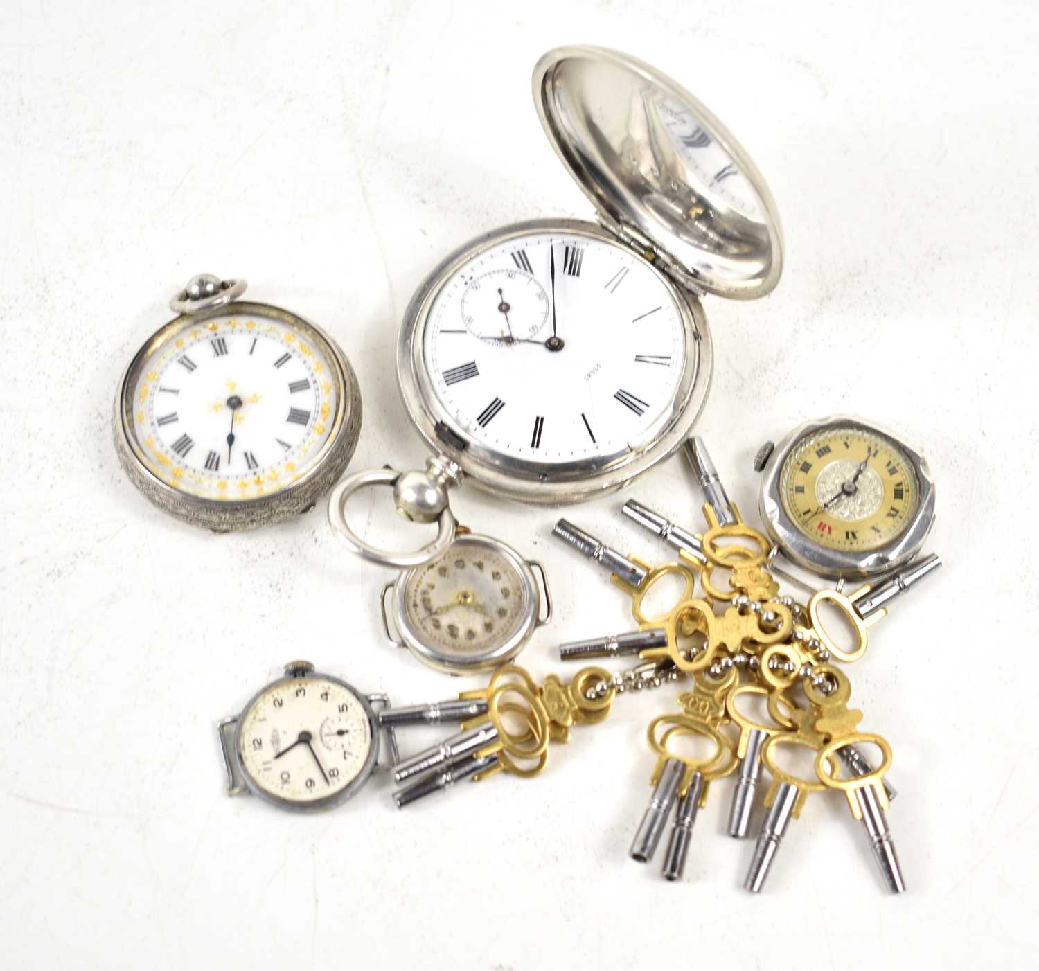 Five silver cased wrist and pocket watches, two having white enamel dials, together with a group