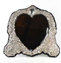 A fine & impressive silver heart form mirror, Sheffield 1995, the silver border embossed profusely