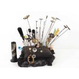 A Victorian pin cushion with thirty eight vintage hat pins of various design, including Art Deco