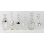 Six cut glass and crystal decanters of various design, together with two porcelain bottle tags for