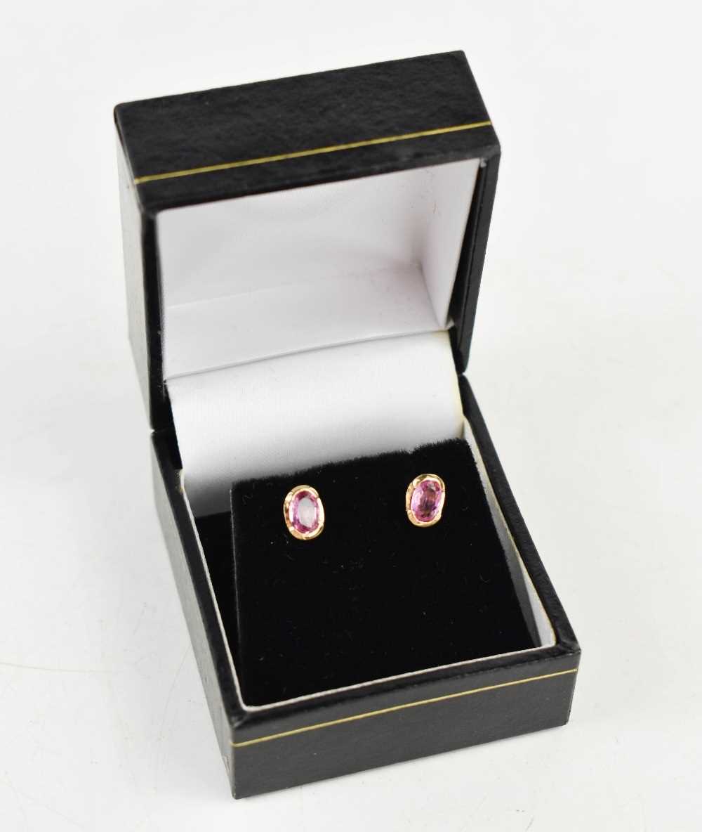 A pair of 18ct gold and pink sapphire earrings, set with oval cut stones of approximately 5.5 by 3. - Image 2 of 2