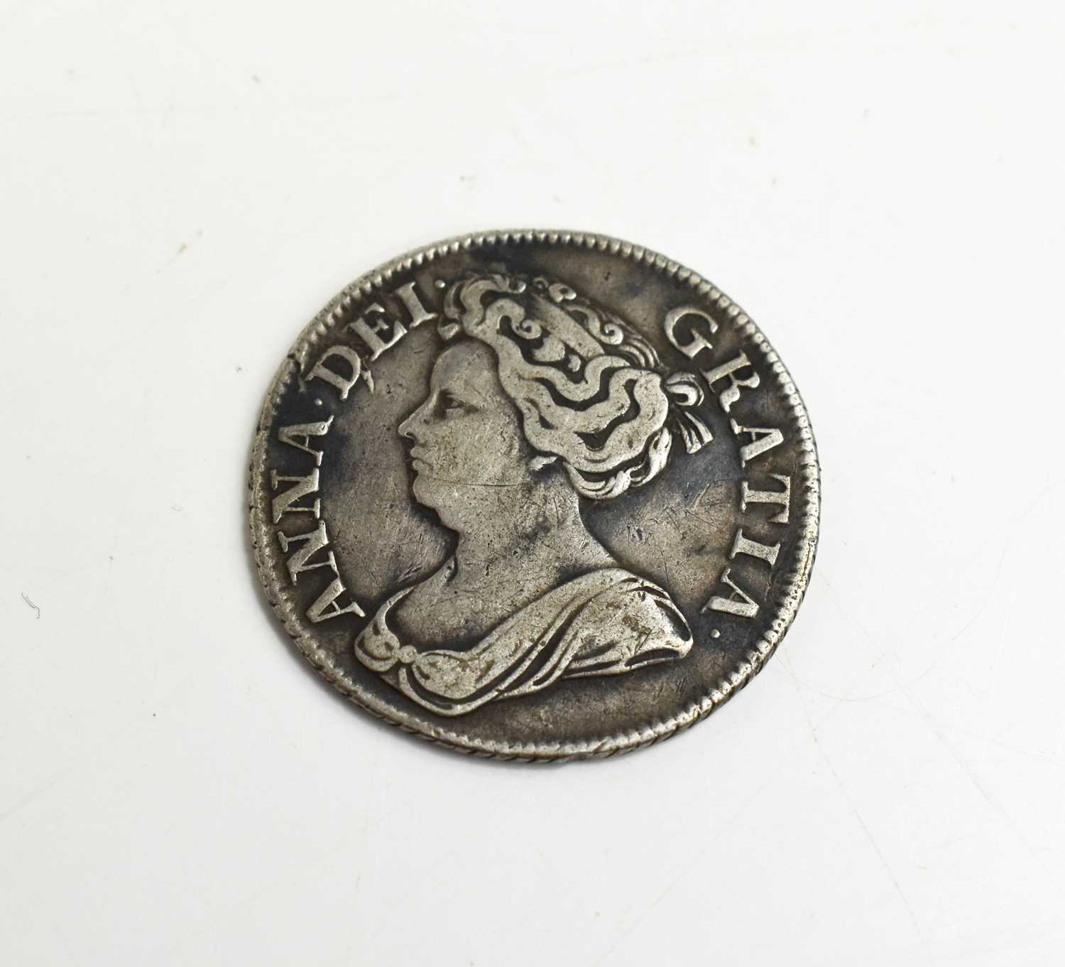 A Queen Anne silver milled shilling dated 1711.