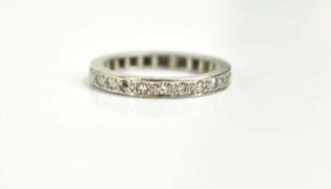 A diamond eternity ring, size J, unmarked testing as either white gold or platinum, 3.5g.