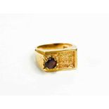 A gentleman's 9ct gold and garnet set ring of modern brutalist form with textured finish, size R,