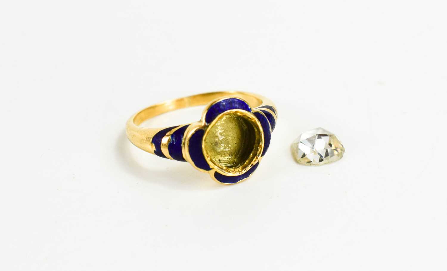 A gentleman's gold, diamond and enamel ring, with curved quatrefoil blue enamel surround to a