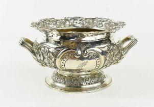A Georgian silver twin handled bowl, London 1894, with pierced and embossed rim of C-scrolls and