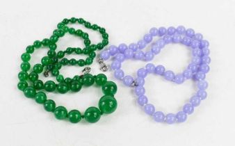 A string of lavender amethyst beads, 45cm long, 37.9g, together with a string of graduated green