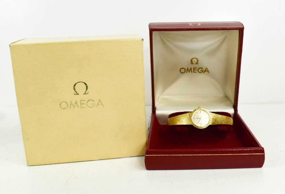 An 18ct gold Omega ladies wristwatch, the circular dial with baton markers, and a 18ct gold bark