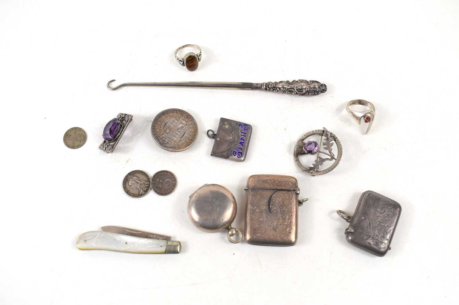 A selection of silver collectables, to include two vesta cases, a stamp holder, button hook,