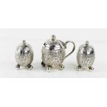 A Victorian silver cruet set comprising a pair of pepperettes and a mustard pot, of ovoid form