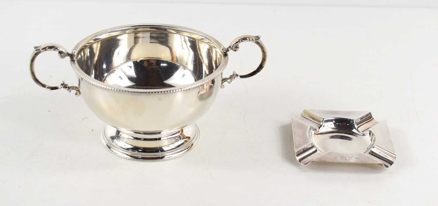 A silver twin handled pedestal bowl together with a small silver ashtray, both hallmarked for