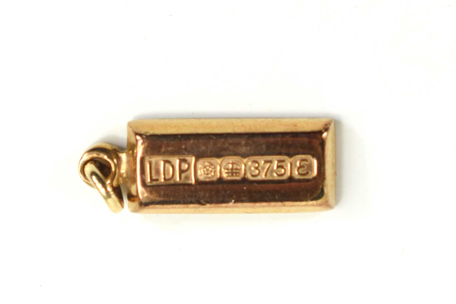 A 9ct gold ingot, Sheffield 1972, on pendant loop, total weight 3.5g.