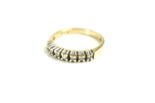 A 9ct gold and diamond seven stone ring, size Q, 3.2g.