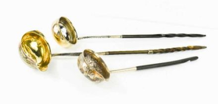 Three 19th century horn and silver ladles, of various style, one with George II coin inset to the
