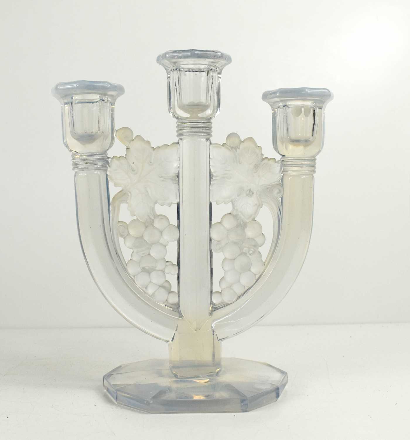 A Lalique style pressed glass candelabra, the three branches united by grape and vine decoration,