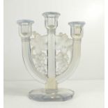 A Lalique style pressed glass candelabra, the three branches united by grape and vine decoration,