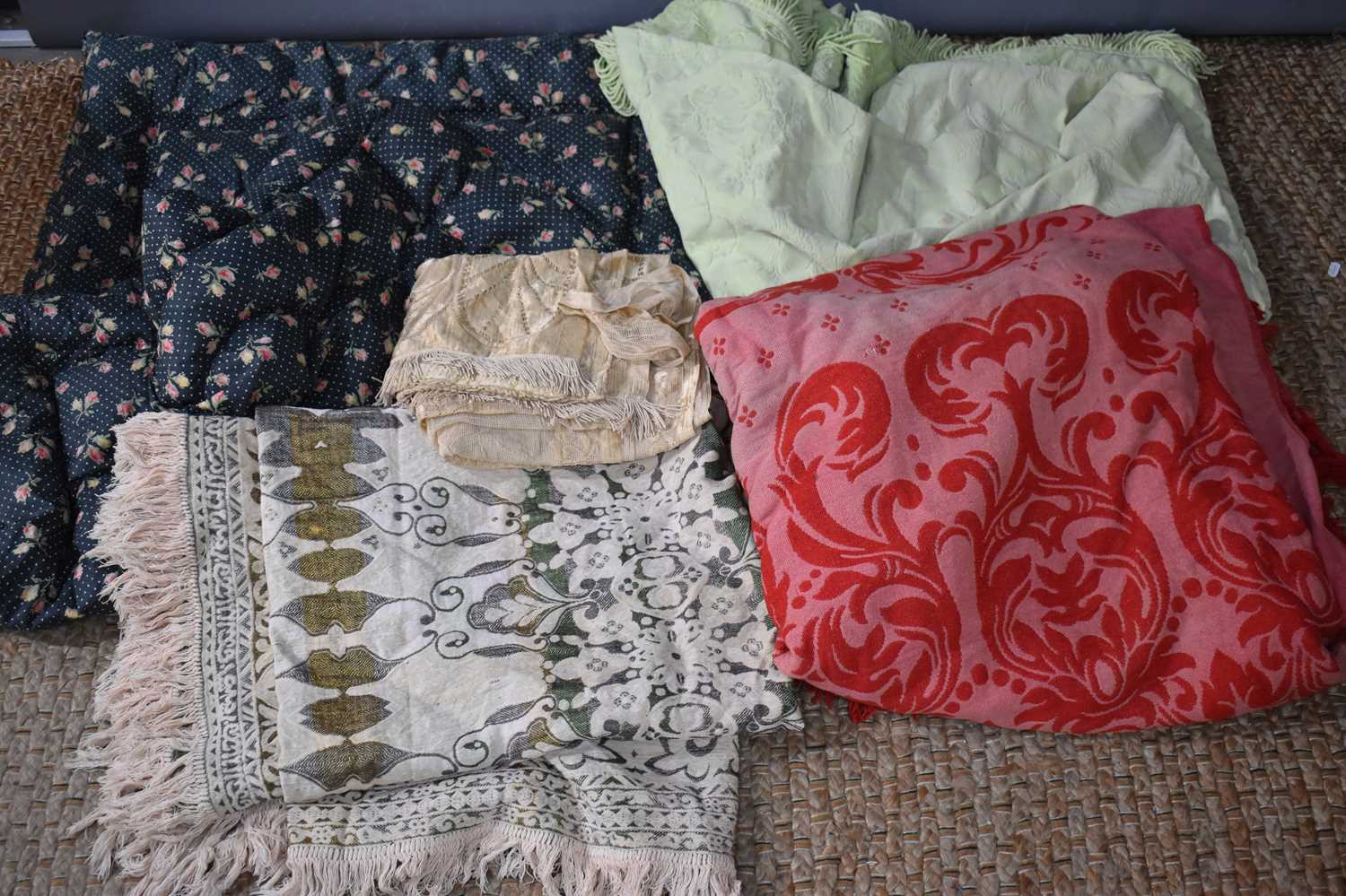 A group of vintage linens comprising a pale green counterpane, a vintage mid century quilt, having