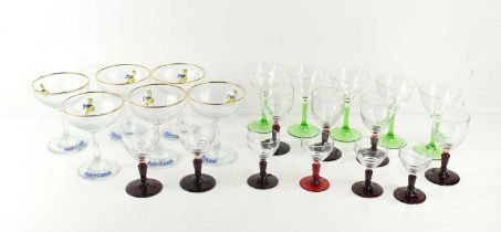 A group of six Babycham glasses together with a group of sherry and liqueur glasses with red stems