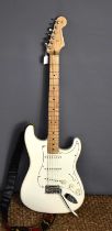 A Fender Stratocaster electric guitar in ivory colour, with maple neck, serial number MX20045453.