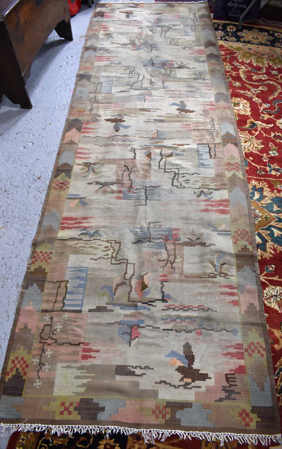 A Turkish wool kelim rug, with abstracted geometric motifs in pastel and neutral tones, with cream