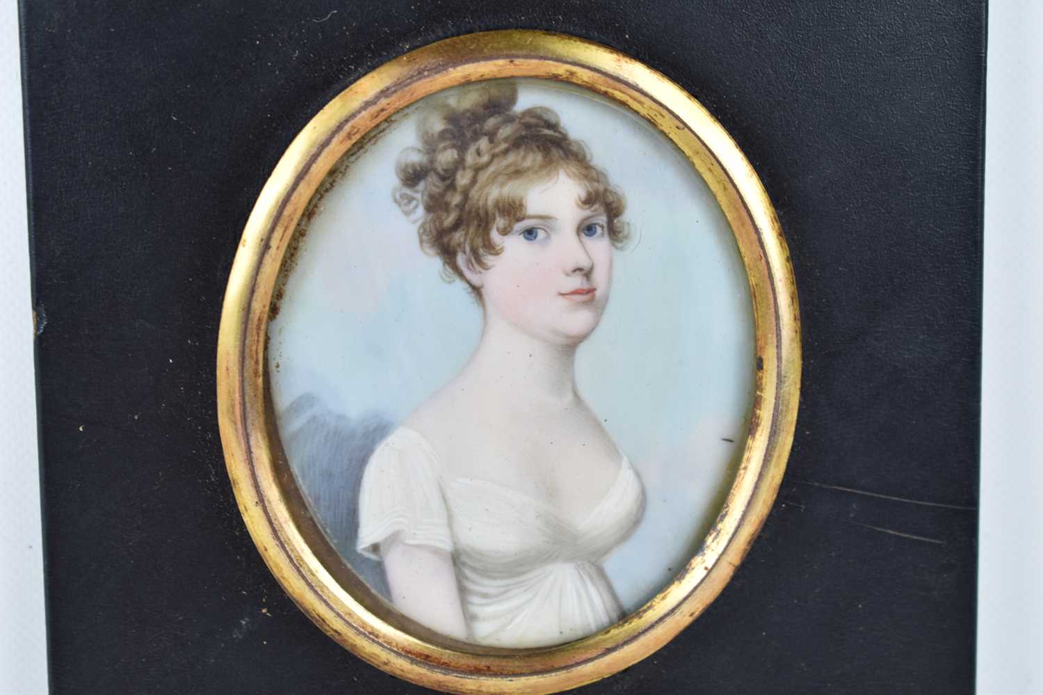 British School: A 19th century portrait miniature of a young woman in a white dress, watercolour - Image 2 of 3