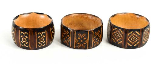 Three 19th century Tunbridge Ware napkin rings, one of rounded form, and two octagonal, each with