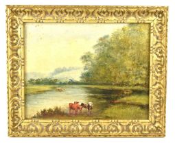 An early 20th century oil on board depicting cattle by the river bank with trees in the