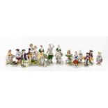 A selection of German porcelain figurines, predominantly Sitzendorf examples including a pair of