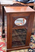 An Edwardian mahogany music cabinet, with glass door.